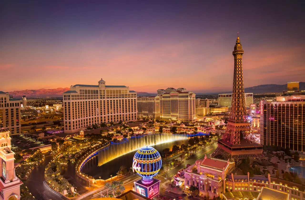 The Las Vegas Strip at dusk with the Bellagio fountains, Caesars Palace and the Paris Las Vegas Eiffel Tower