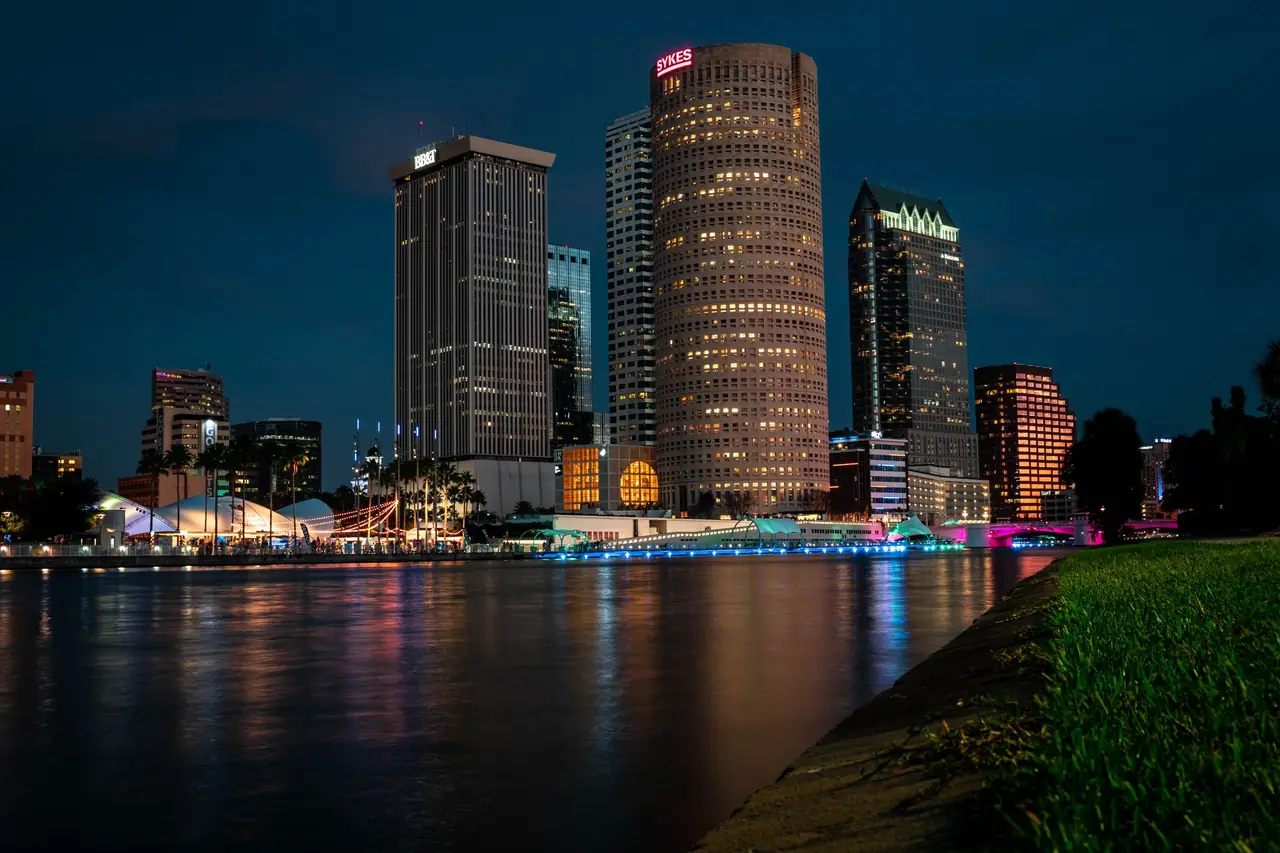 Downtown Tampa skyline at night along the Hillsborough River, including the cylindrical Rivergate Tower