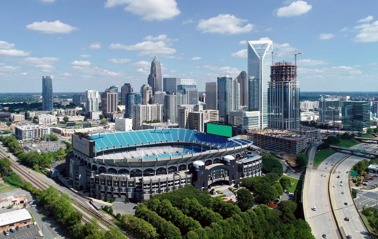Aerial view of Uptown Charlotte's skyline with Bank of America Stadium in the foreground