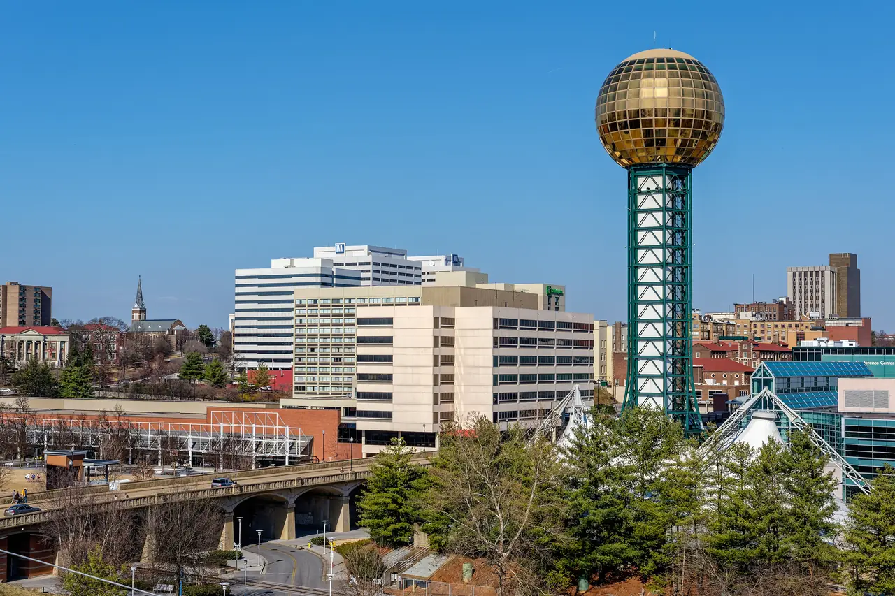 The Sunsphere's gold-glass ball atop its steel tower in World's Fair Park, with downtown Knoxville behind